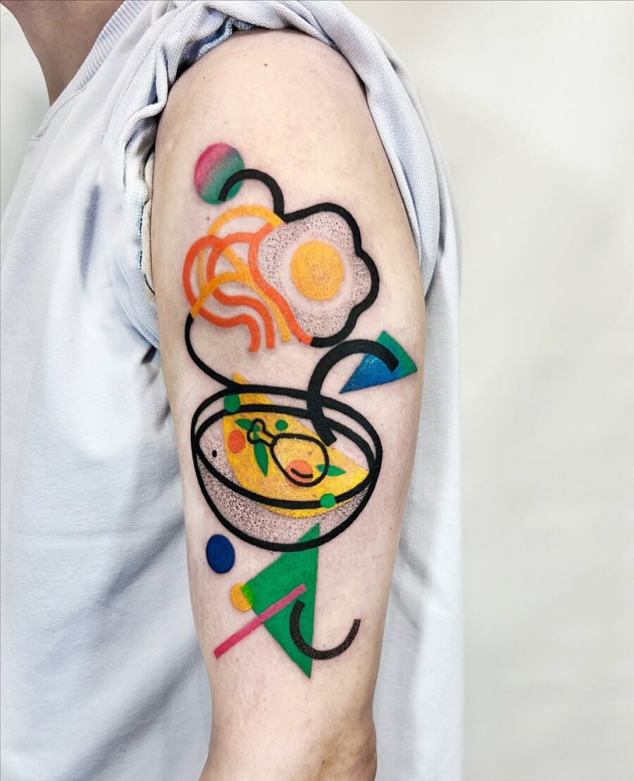 This whimsical tattoo features a colorful egg design layered with abstract elements.