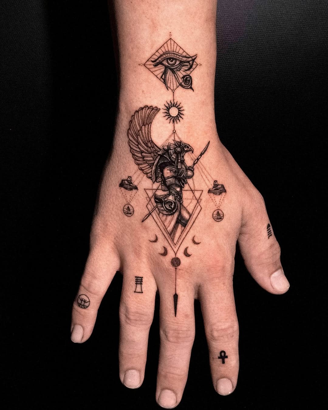 Intricate Egyptian symbols grace this hand tattoo Tattoo Design