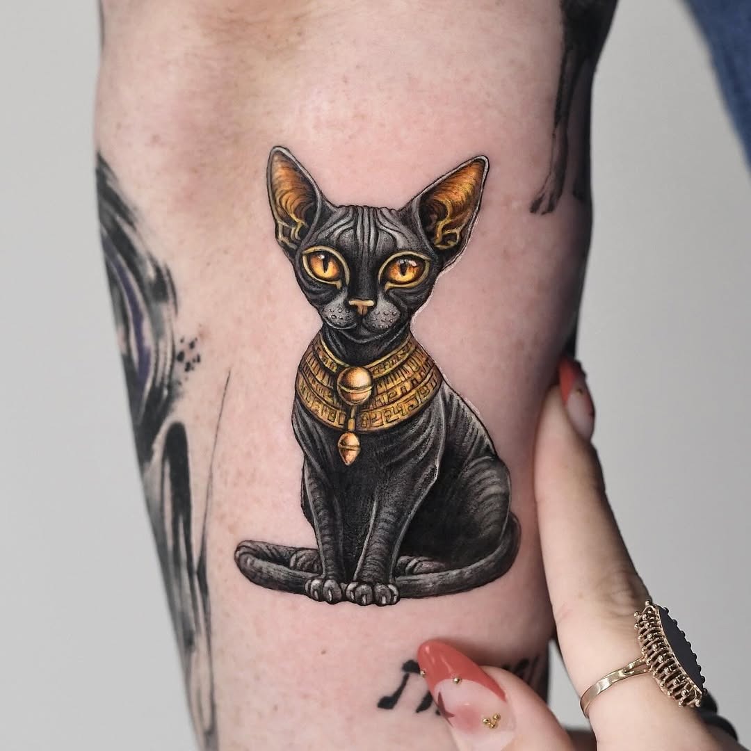 Majestic Egyptian Cat Tattoo with Golden Accents Tattoo Design