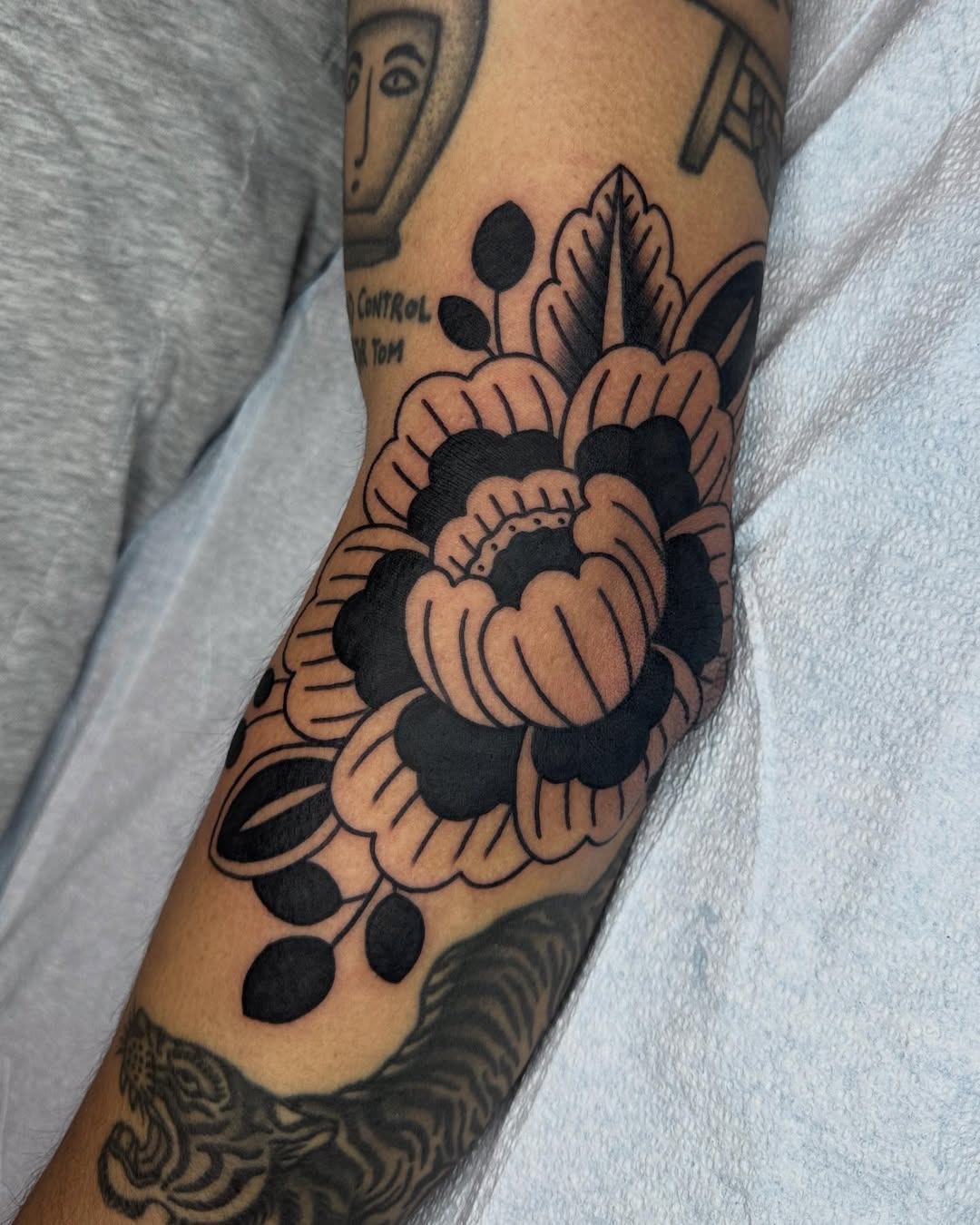 Bold floral elbow tattoo with intricate details Tattoo Design