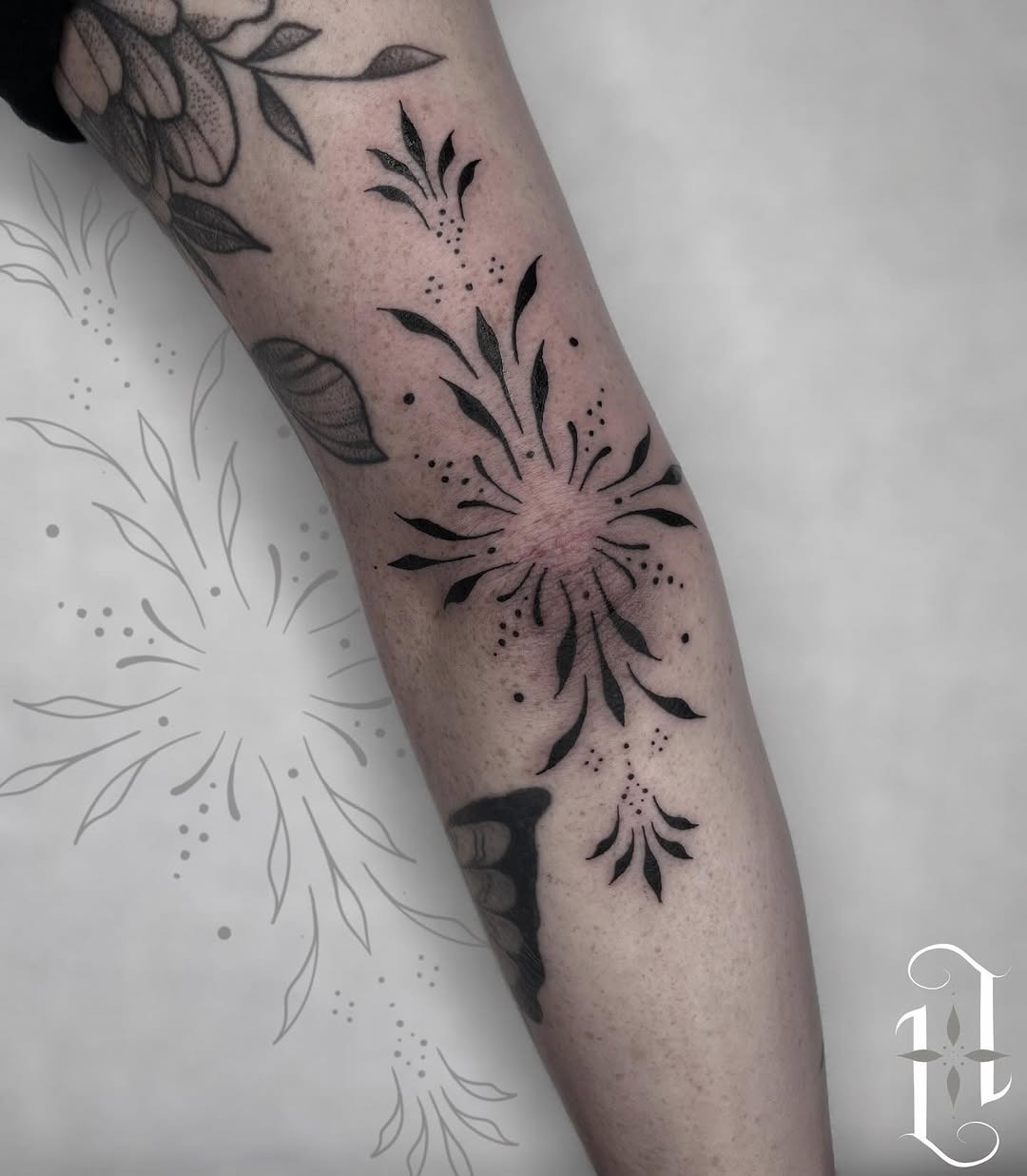 Elegant floral elbow tattoo with bold black ink Tattoo Design