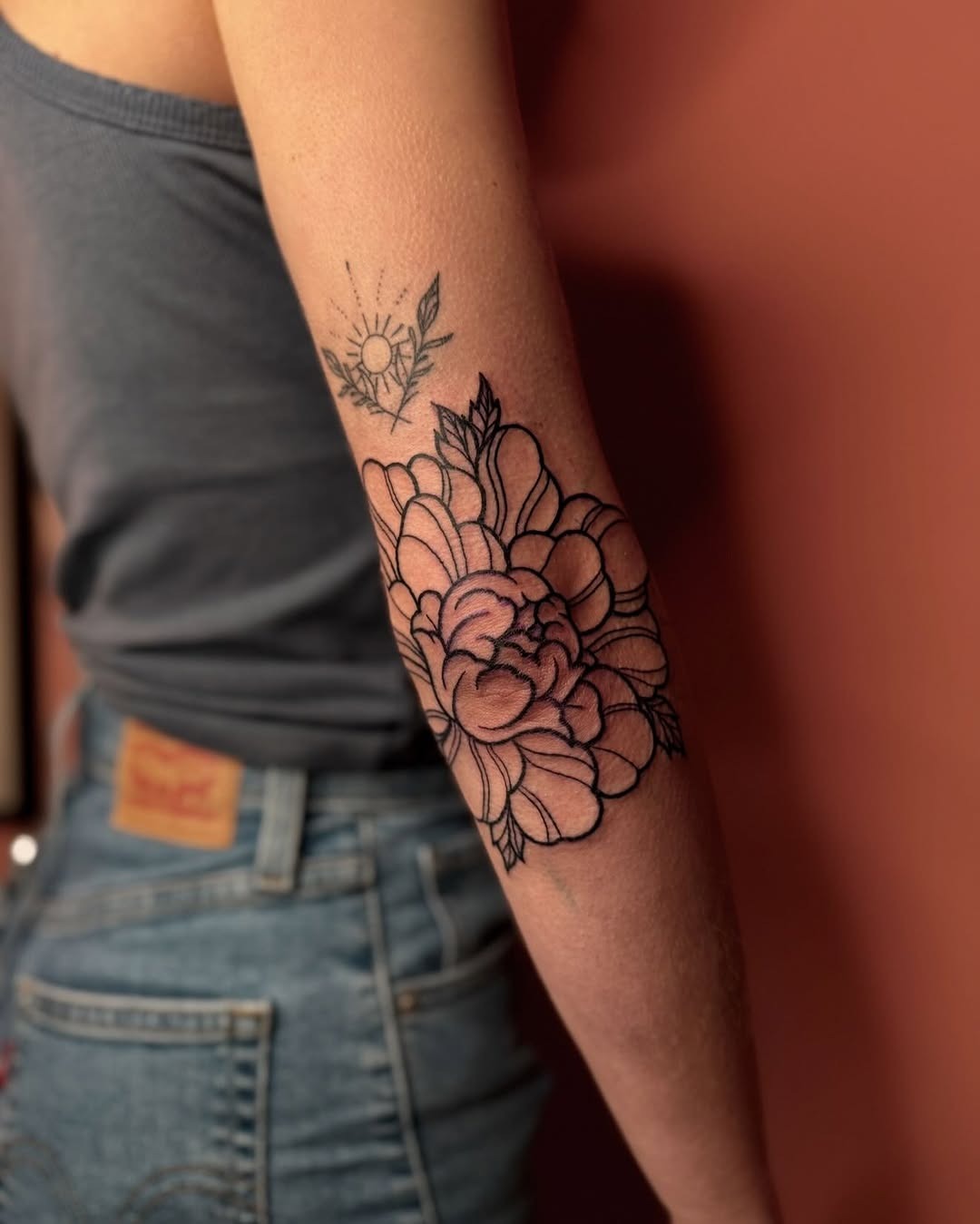 Elegant floral elbow tattoo with subtle shading Tattoo Design