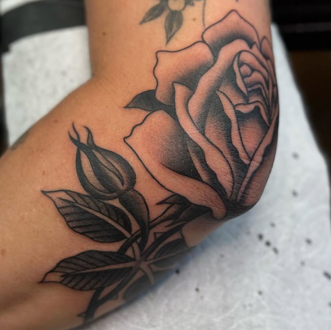 Elegant rose tattoo enhancing elbow aesthetics Tattoo Design
