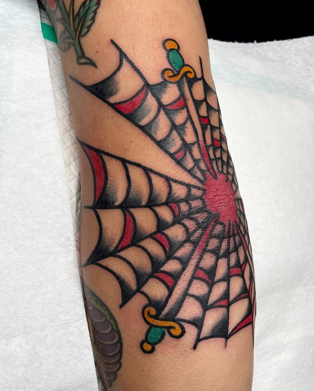 Intricate spider web tattoo on the elbow Tattoo Design