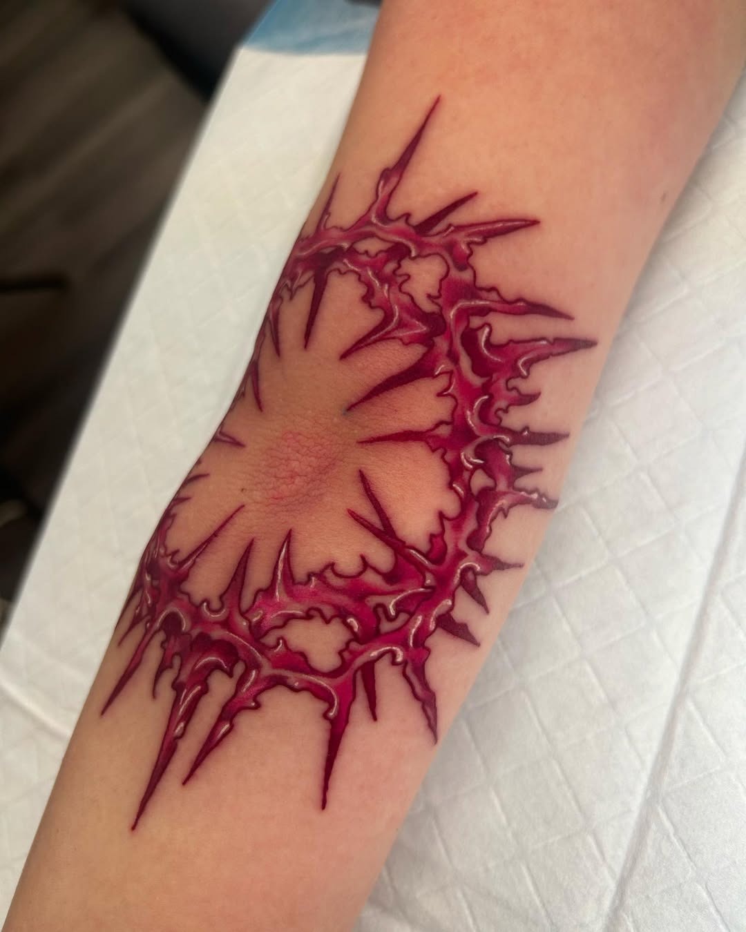 Intricate spiky elbow tattoo with bold colors Tattoo Design