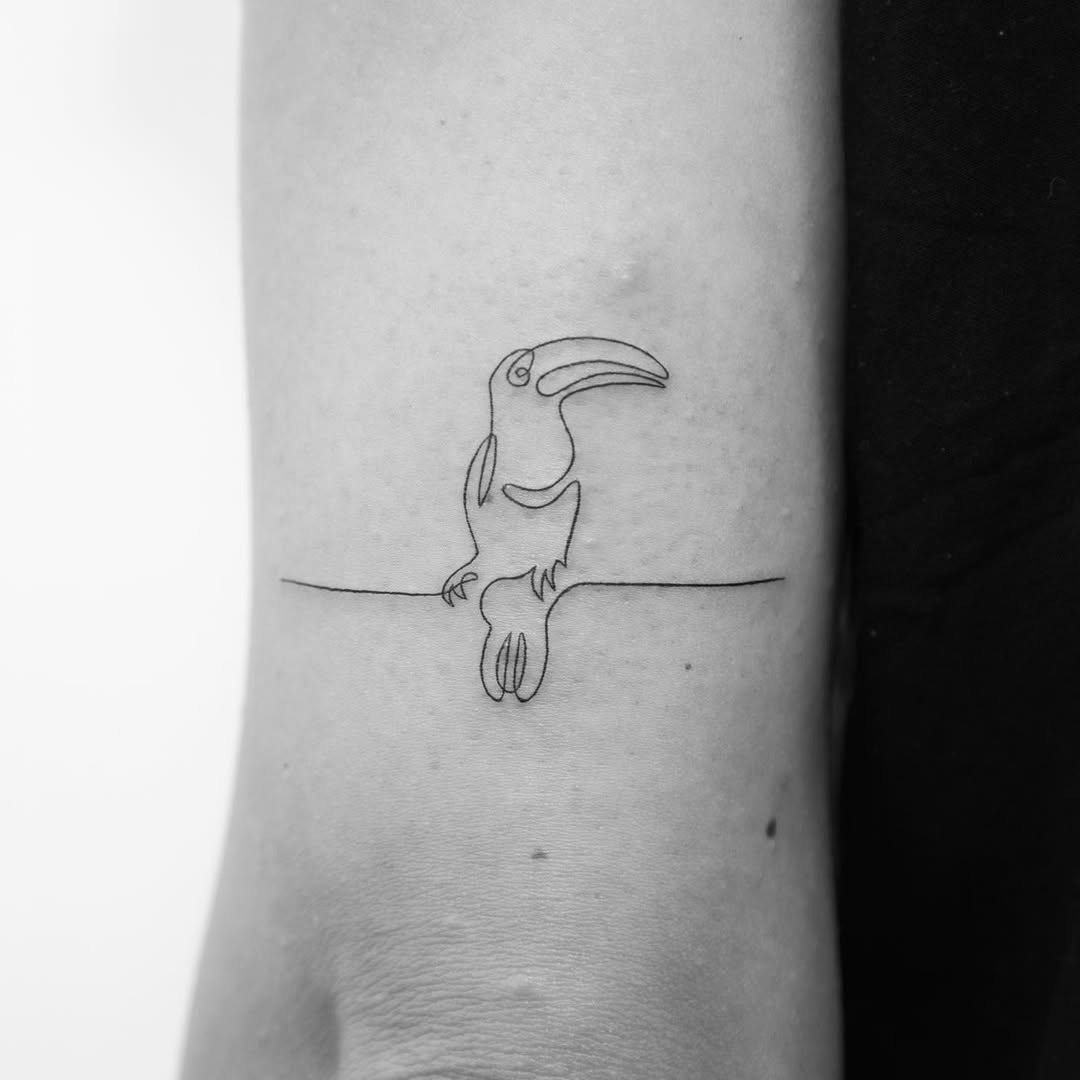 Minimalist toucan design on elbow tattoo Tattoo Design