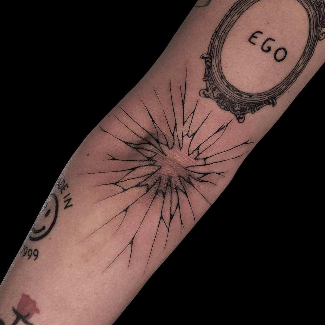 Striking sunburst design on elbow tattoo. Tattoo Design