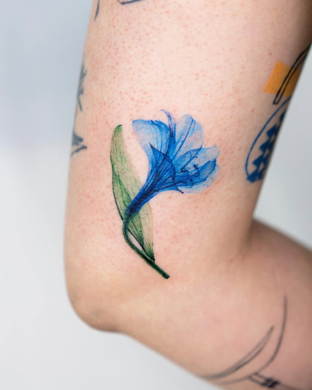 Stunning blue flower on elbow tattoo Tattoo Design
