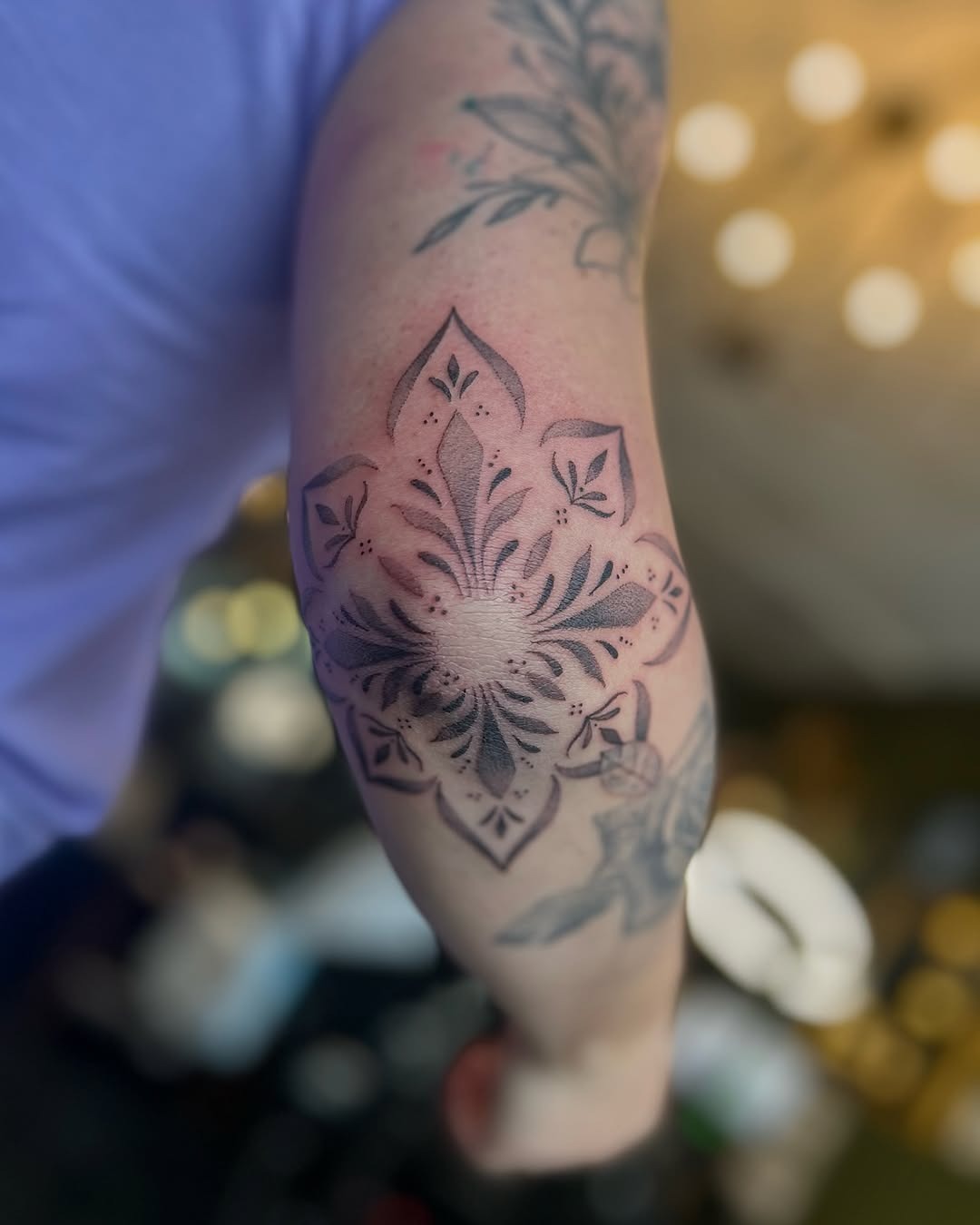 Stunning floral elbow tattoo in black and gray Tattoo Design
