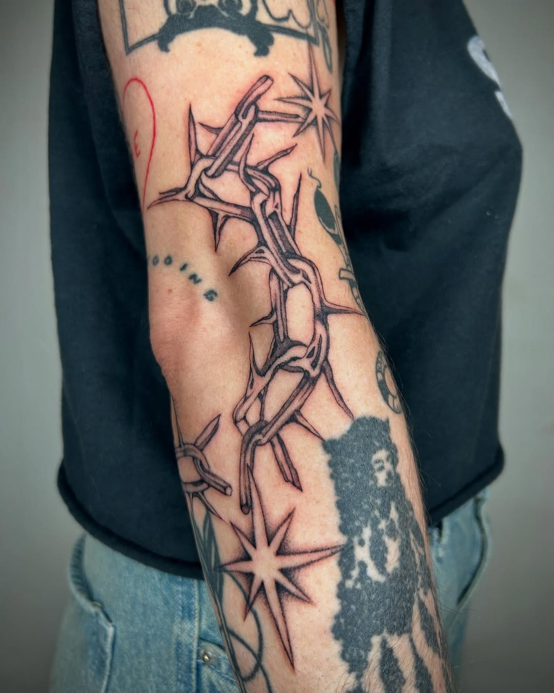Unique chain and star elbow tattoo design Tattoo Design