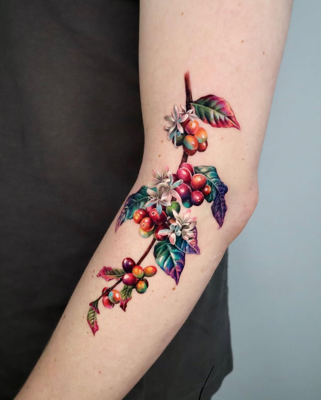 Vibrant botanical elbow tattoo showcasing nature’s beauty Tattoo Design