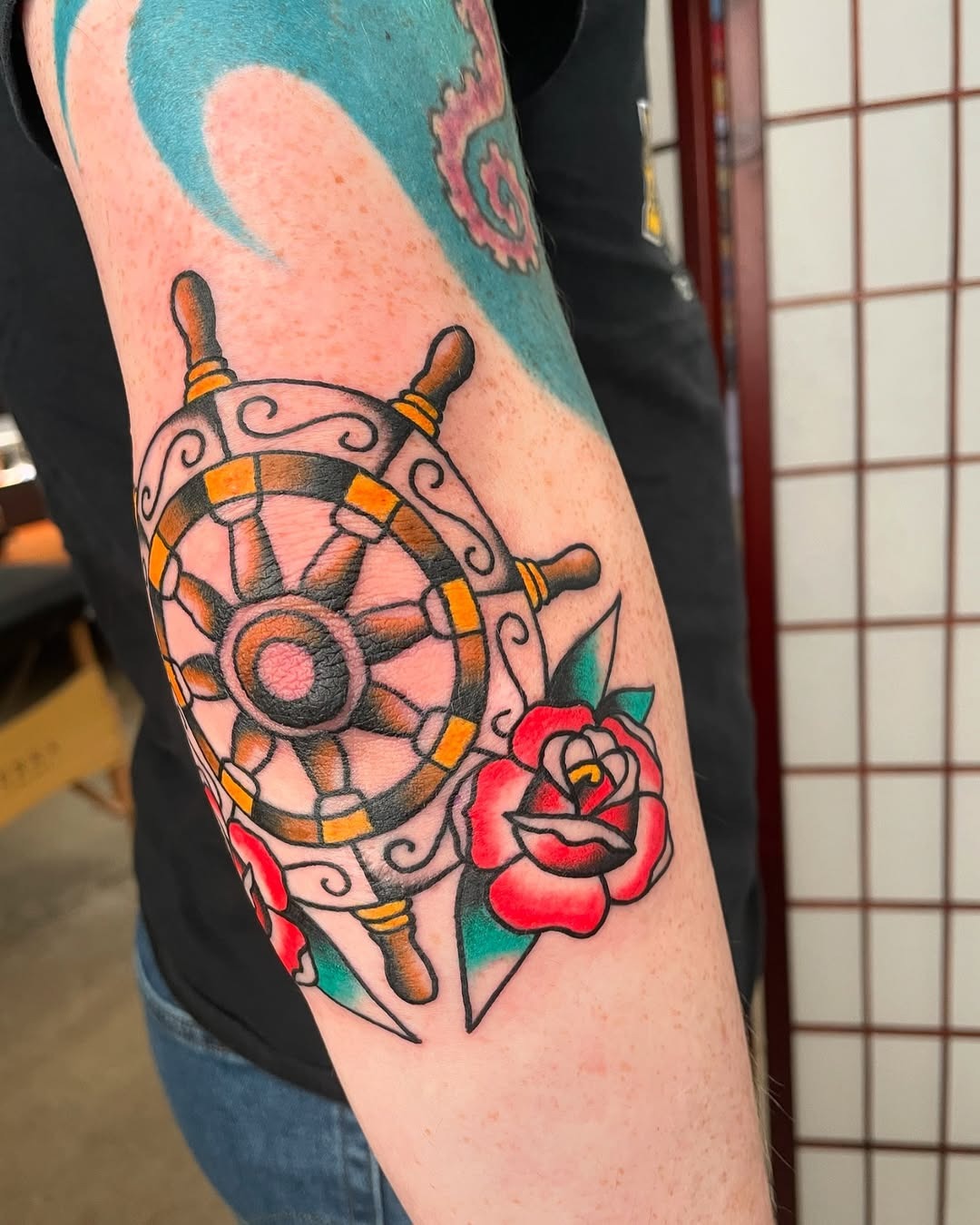 Vibrant Elbow Tattoo Featuring Nautical Elements Tattoo Design