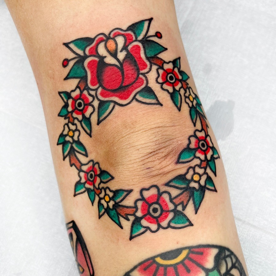 Vibrant floral elbow tattoo with bold colors Tattoo Design