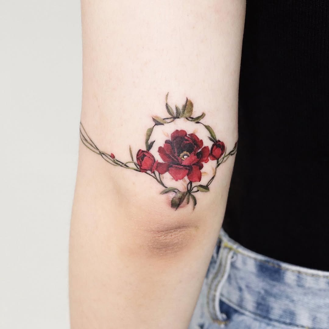 Vibrant red roses enhance elbow tattoo aesthetics Tattoo Design