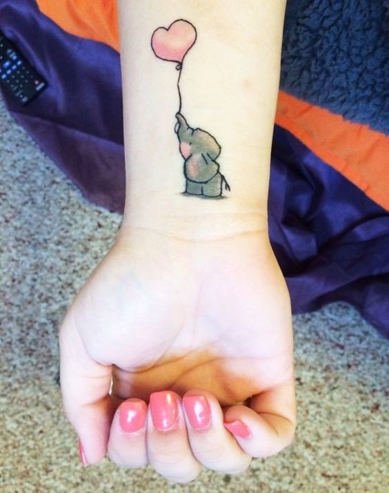 A beautiful elephant outline tattoo holding a balloon in its trunk Tattoo Design