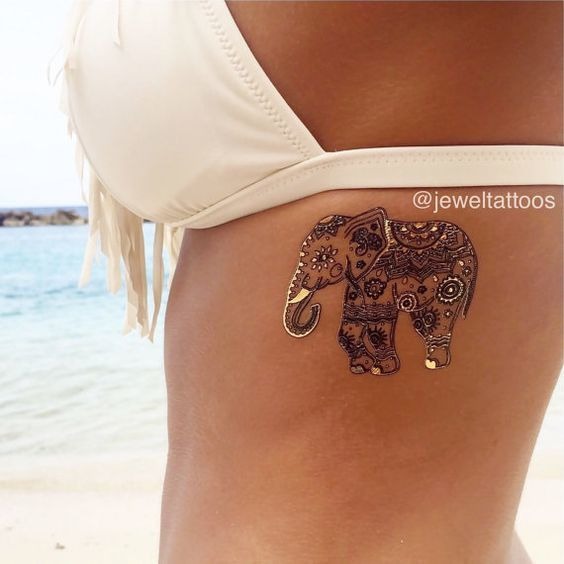 A beautifully decorated mandala elephant tattoo on the lady’s chest Tattoo Design