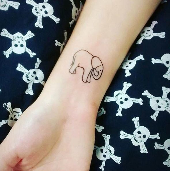 Simple clean elephant outline tattoo on the wrist Tattoo Design
