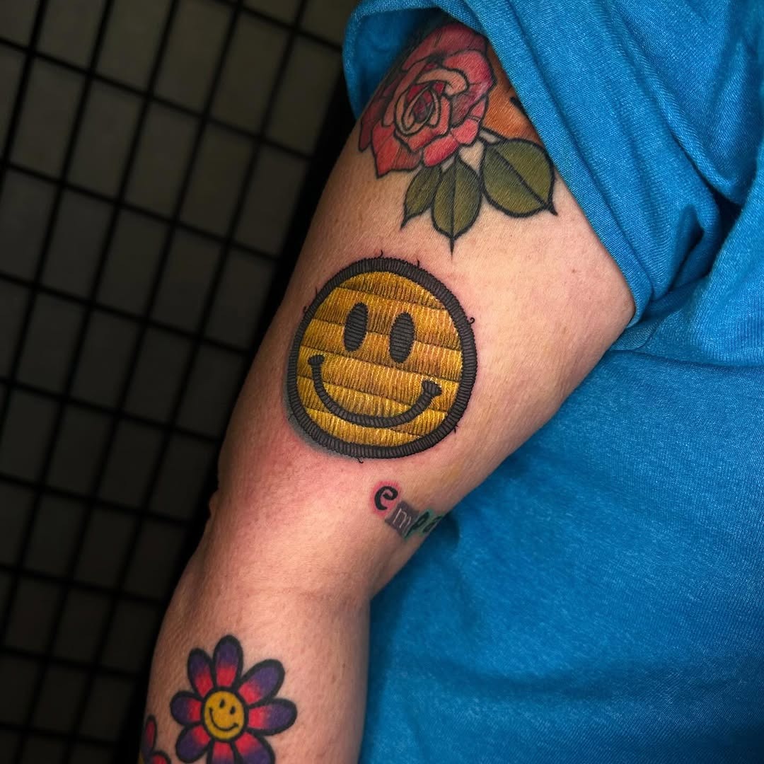 Unique embroidered smiley face tattoo design Tattoo Design