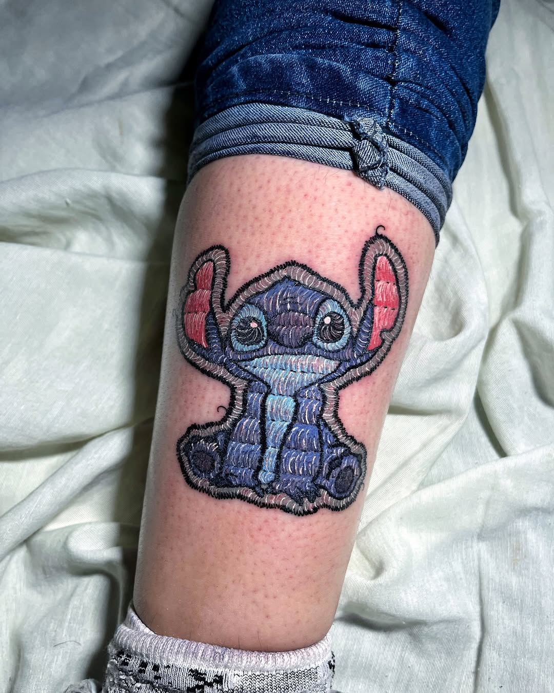 Unique Embroidery Tattoo of a Playful Character Tattoo Design