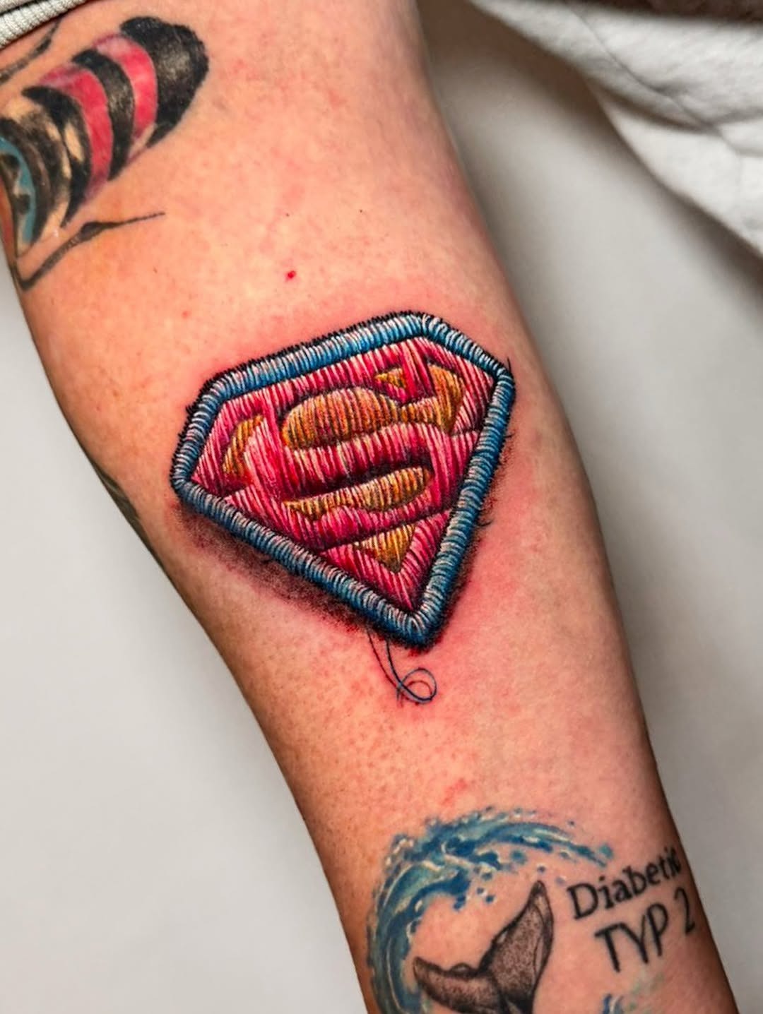 Vibrant embroidery-style Superman tattoo design Tattoo Design
