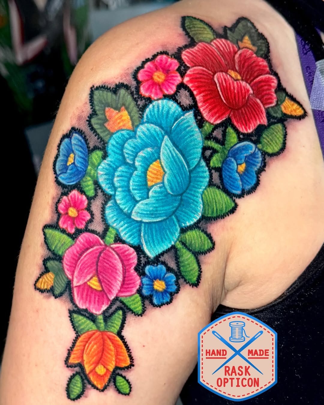 Vibrant floral embroidery tattoo on shoulder Tattoo Design
