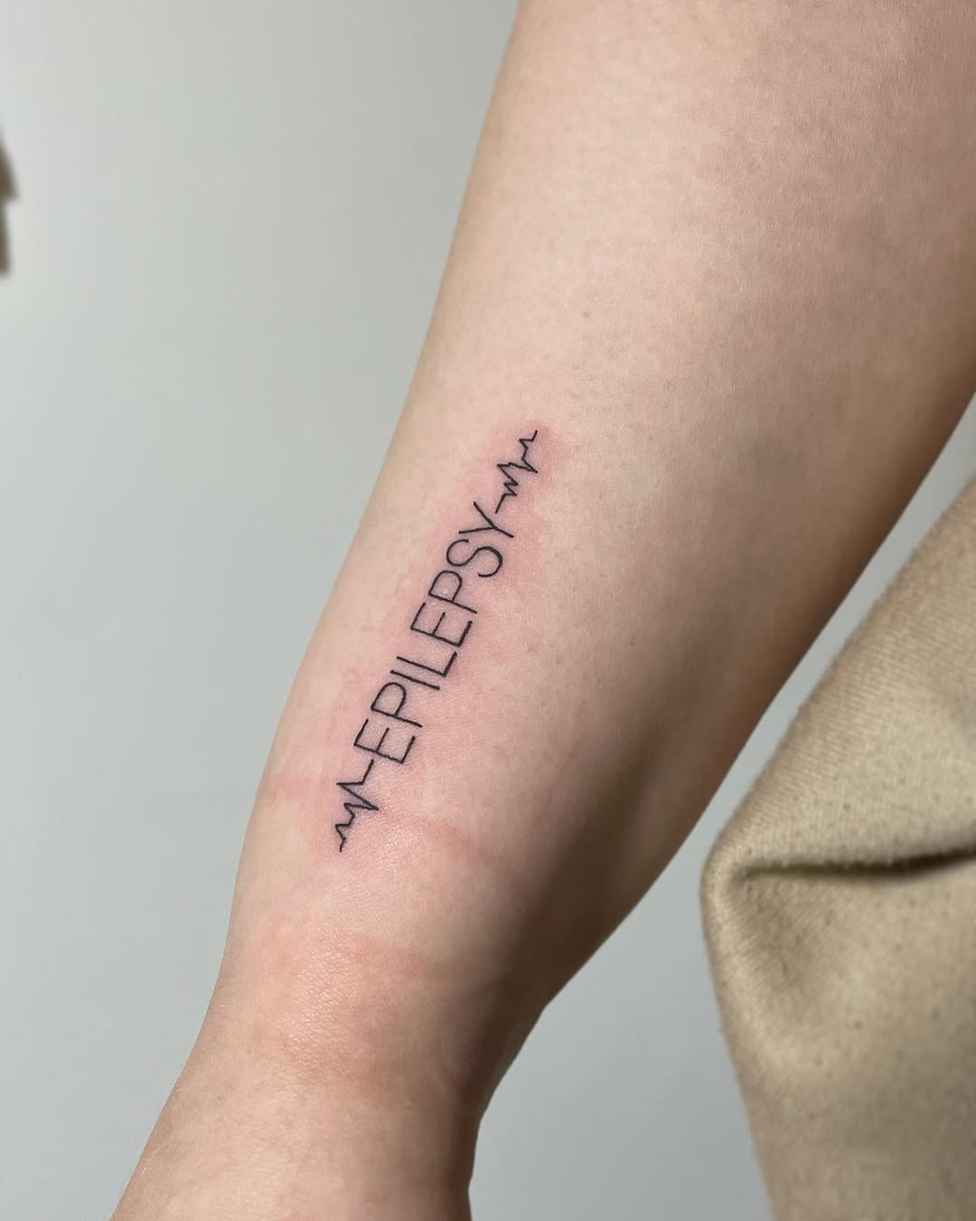 A bold statement on epilepsy awareness Tattoo Design