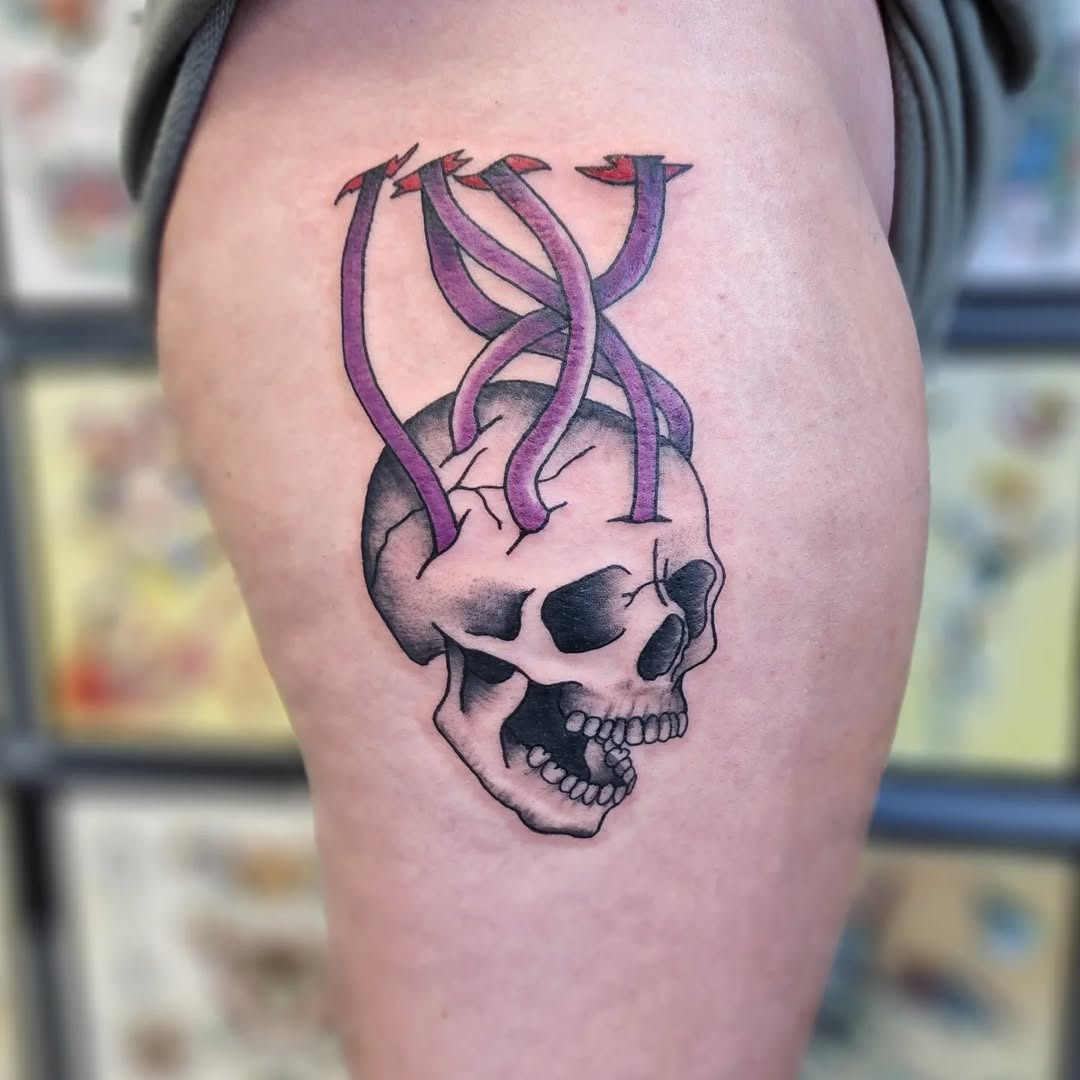 Bold skull with snake motifs in tattoo art Tattoo Design