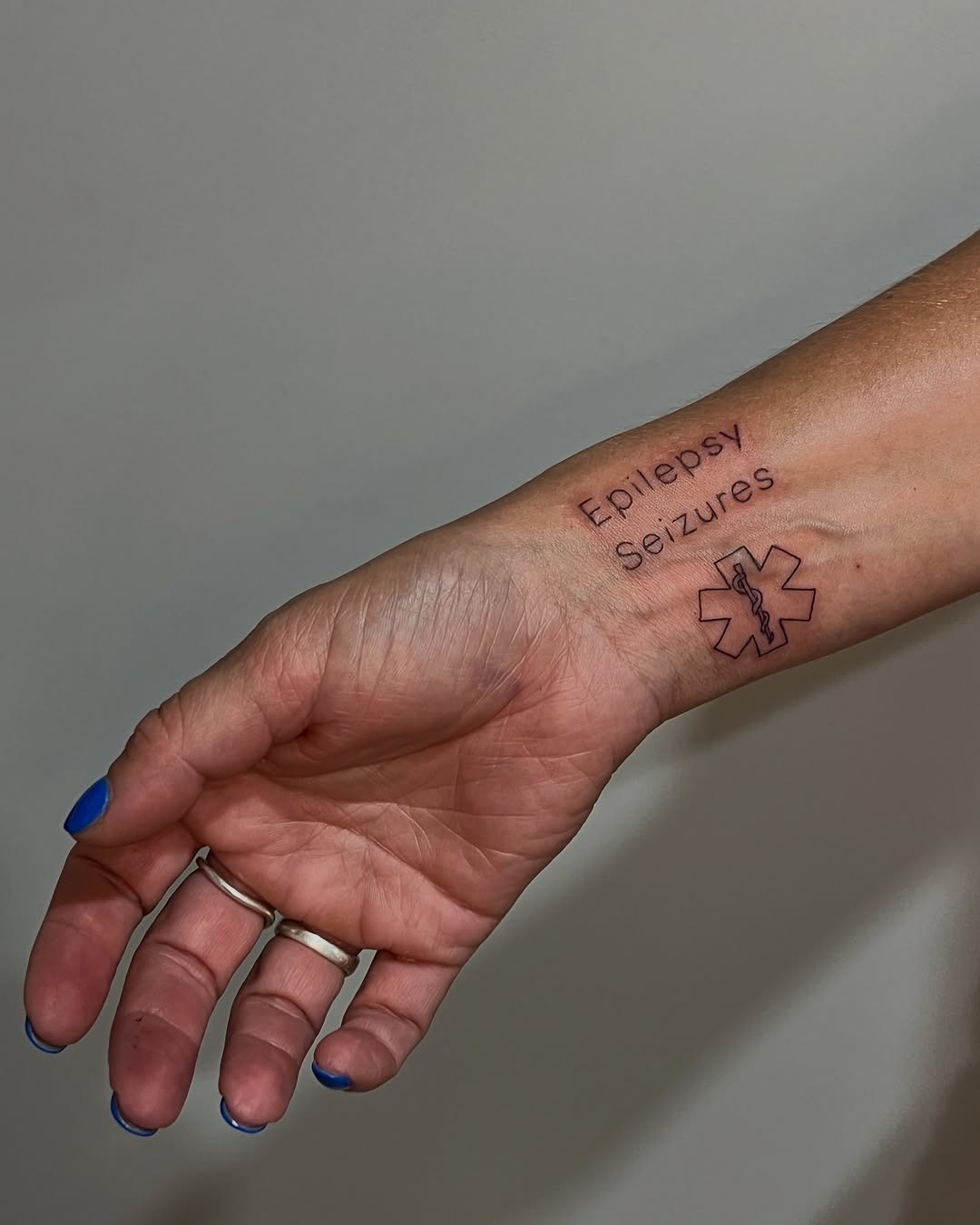 Colorful floral epilepsy awareness tattoo on wrist Tattoo Design
