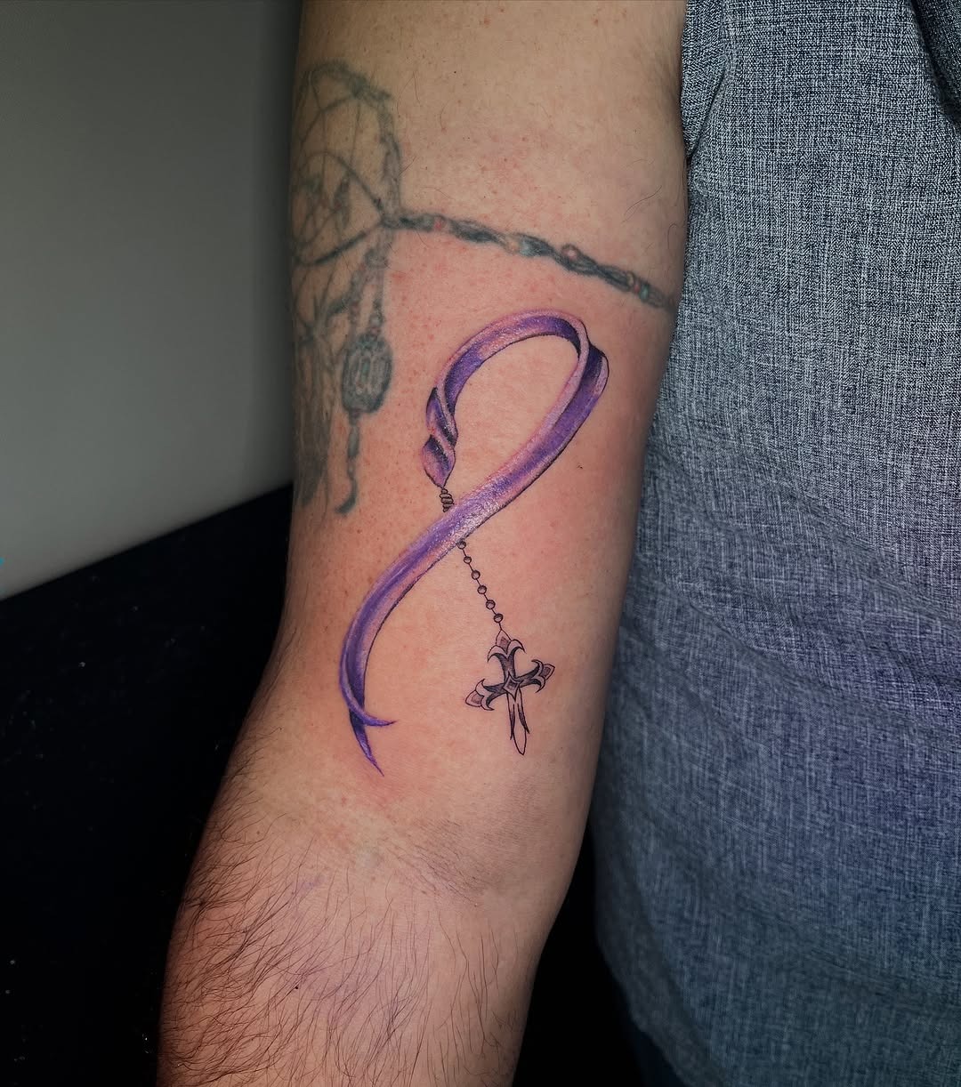 Elegant purple ribbon symbolizes strength and awareness Tattoo Design