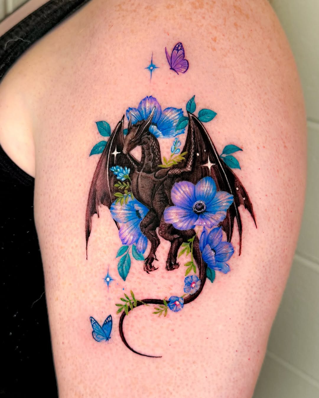 A striking dragon tattoo surrounded by flowers Tattoo Design