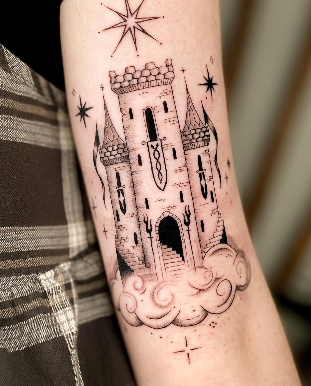 Majestic castle tattoo surrounded by whimsical clouds Tattoo Design