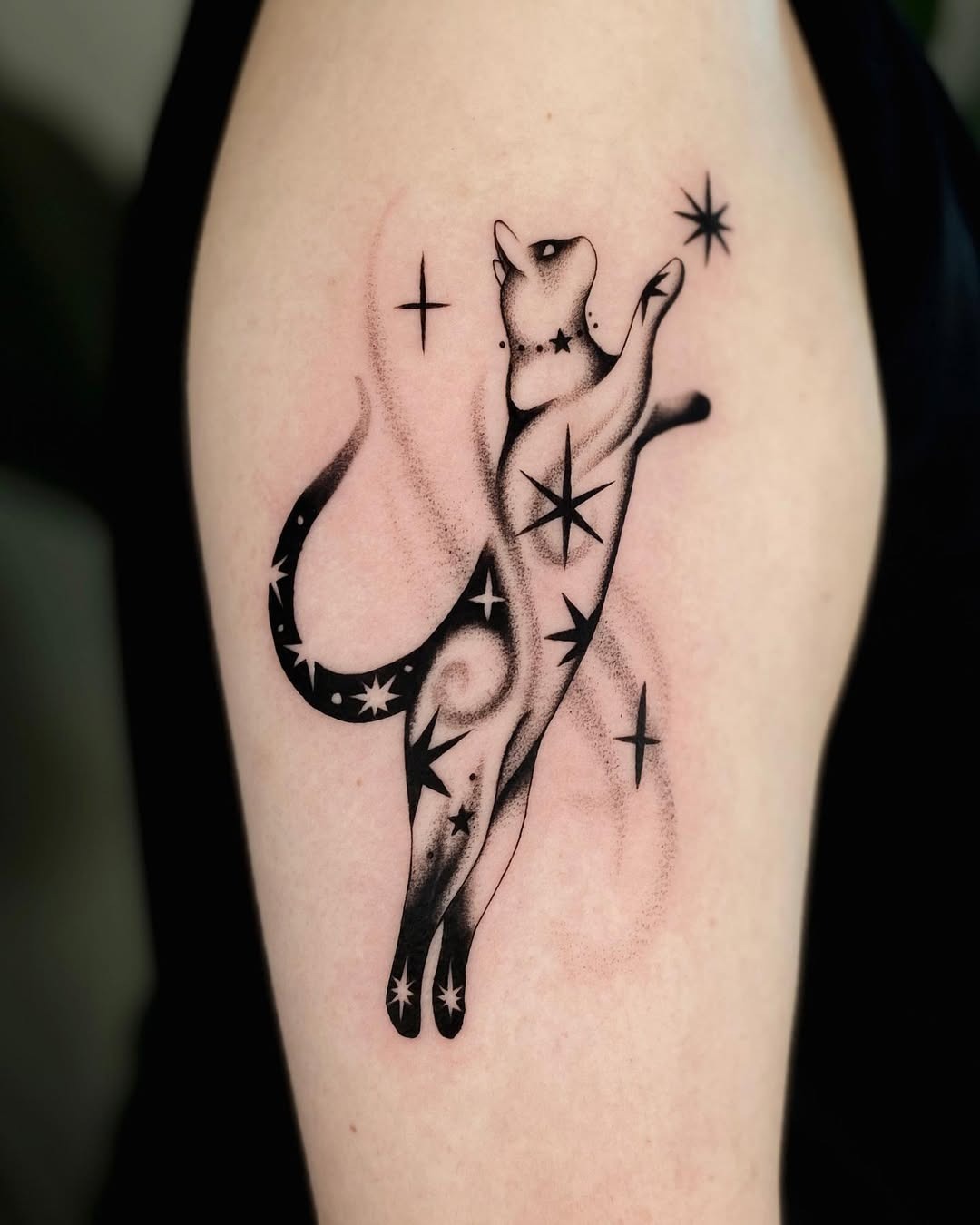 Playful cat tattoo amidst starry swirls Tattoo Design