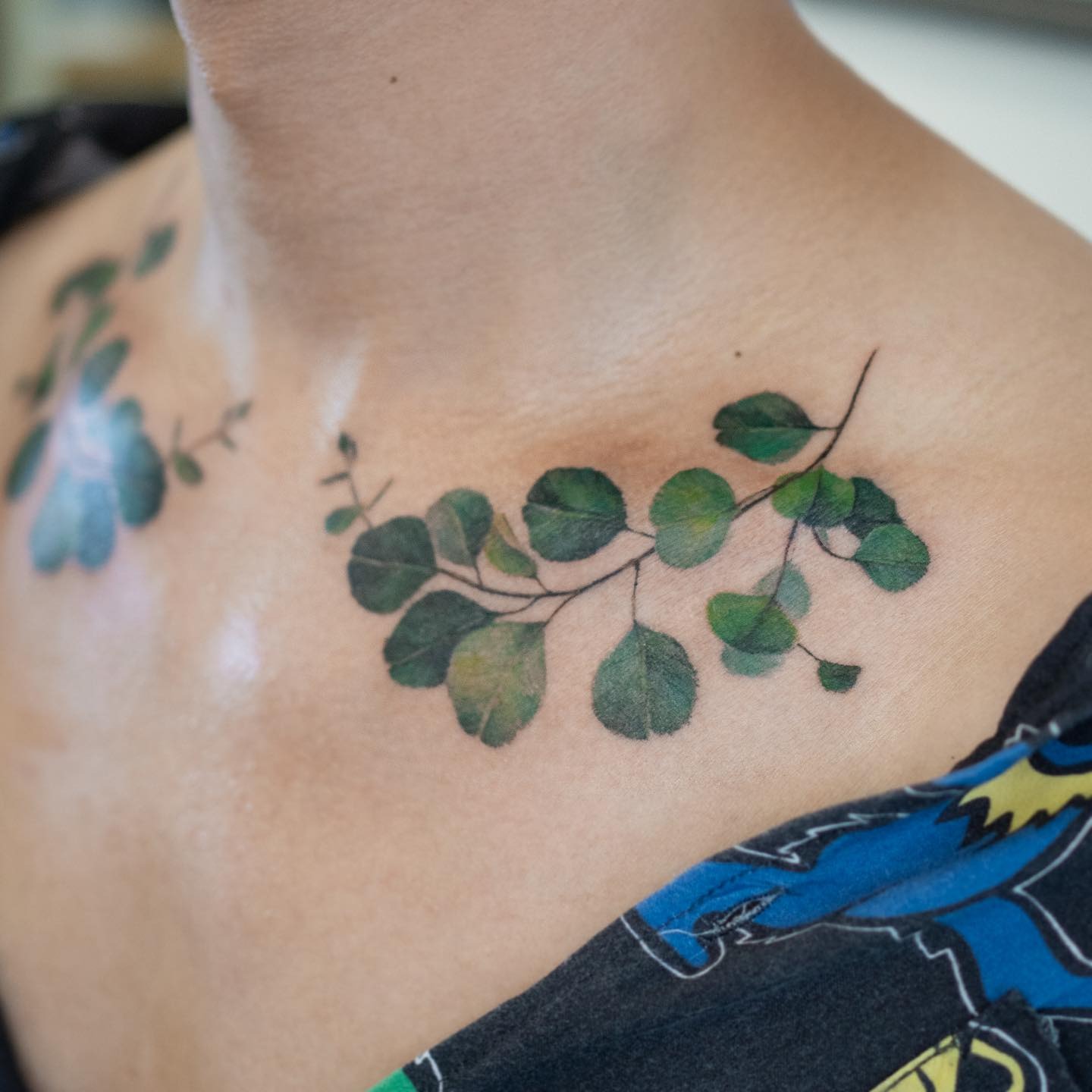 Elegant eucalyptus branch tattoo on collarbone Tattoo Design