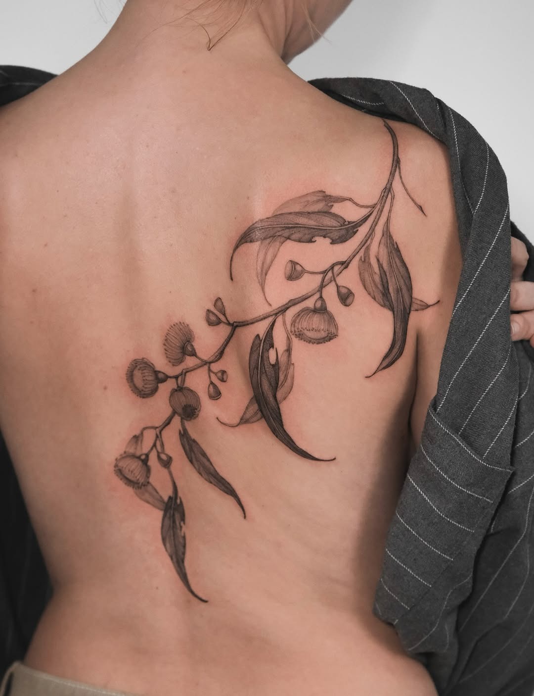 Elegant eucalyptus tattoo enhancing back aesthetics Tattoo Design