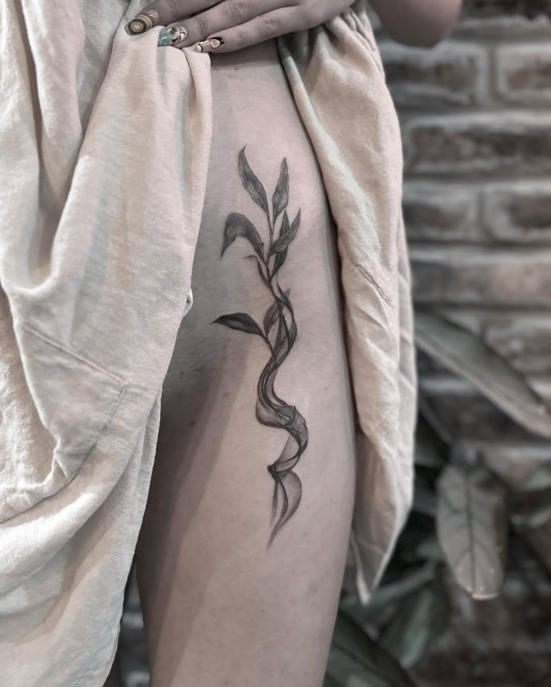 Elegant eucalyptus tattoo with flowing design Tattoo Design