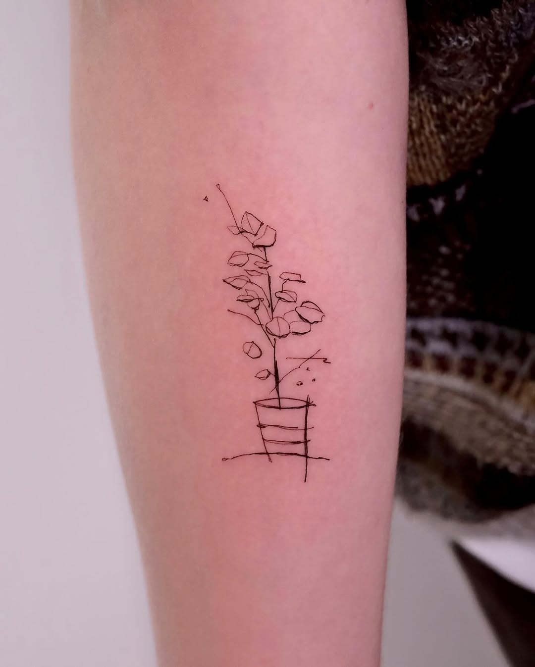 Elegant Minimalist Eucalyptus Tattoo in Pot Tattoo Design