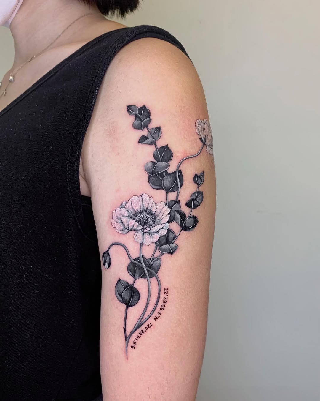 Intricate eucalyptus tattoo with floral accents Tattoo Design