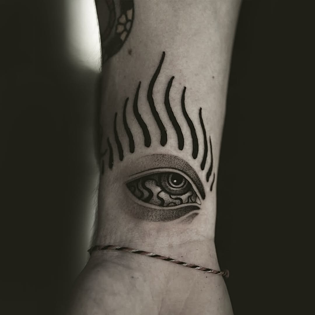 Intricate eye tattoo with striking black ink Tattoo Design