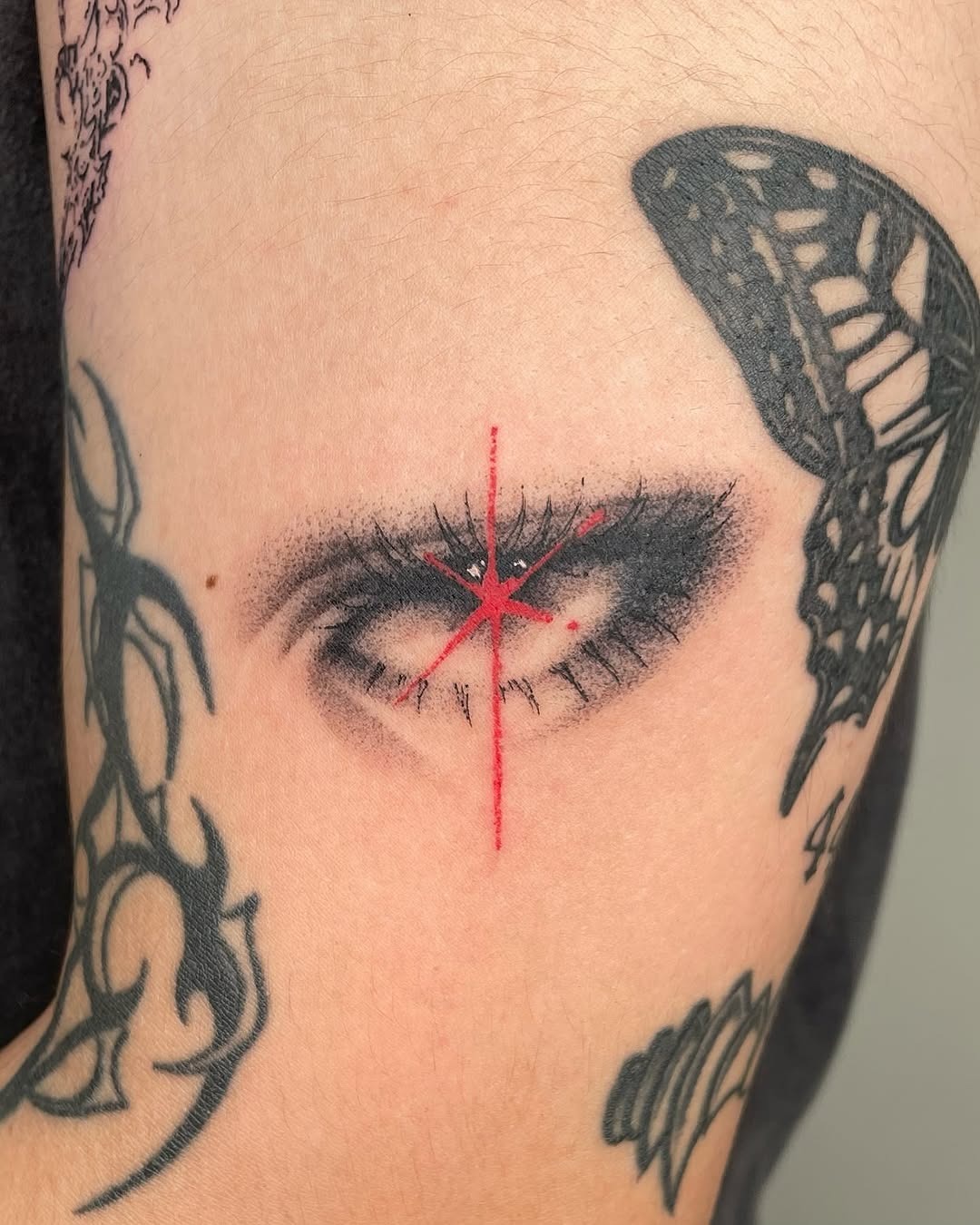 Intricate eye tattoo with striking red accents Tattoo Design