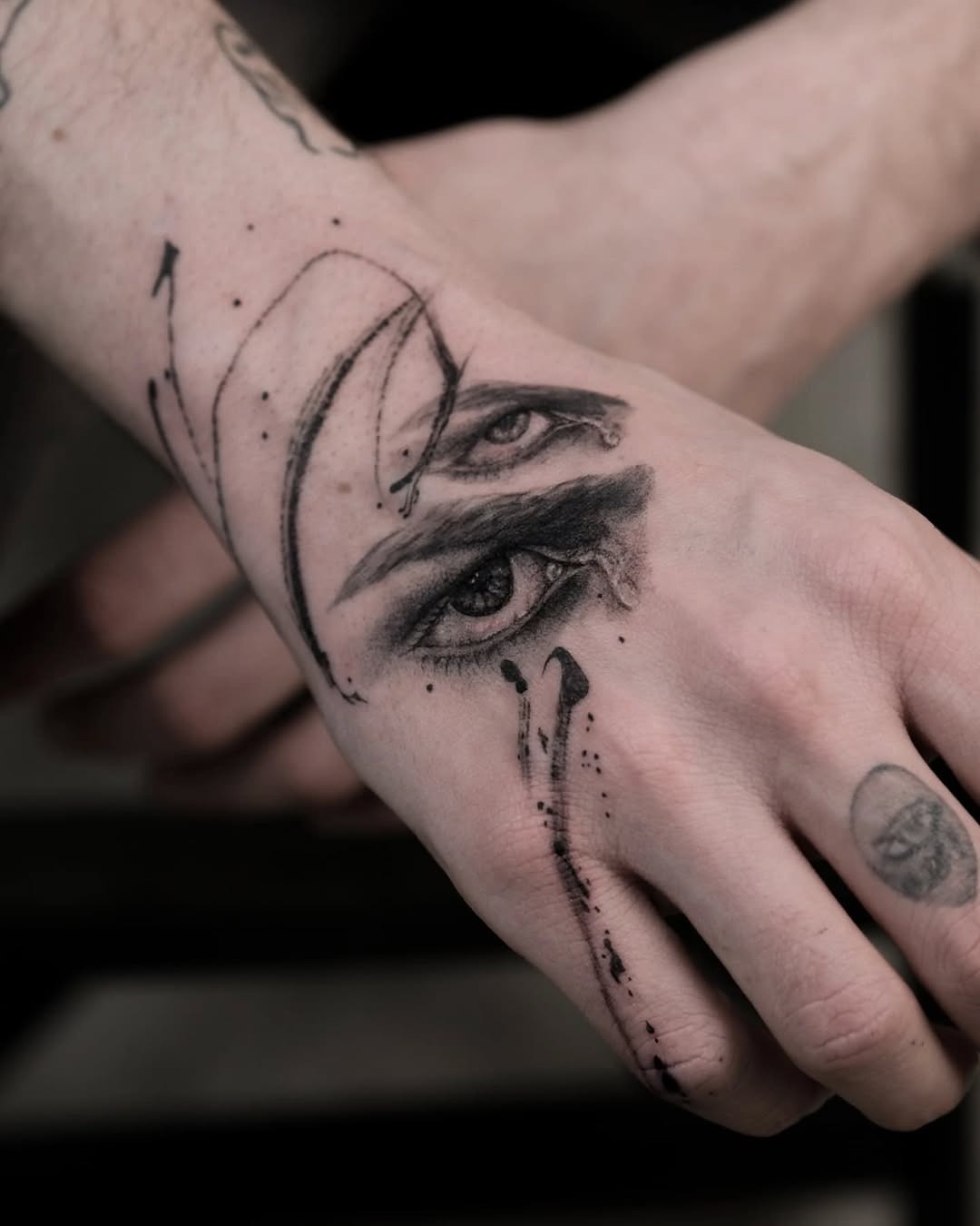 Intricate hand tattoo featuring expressive eyes Tattoo Design
