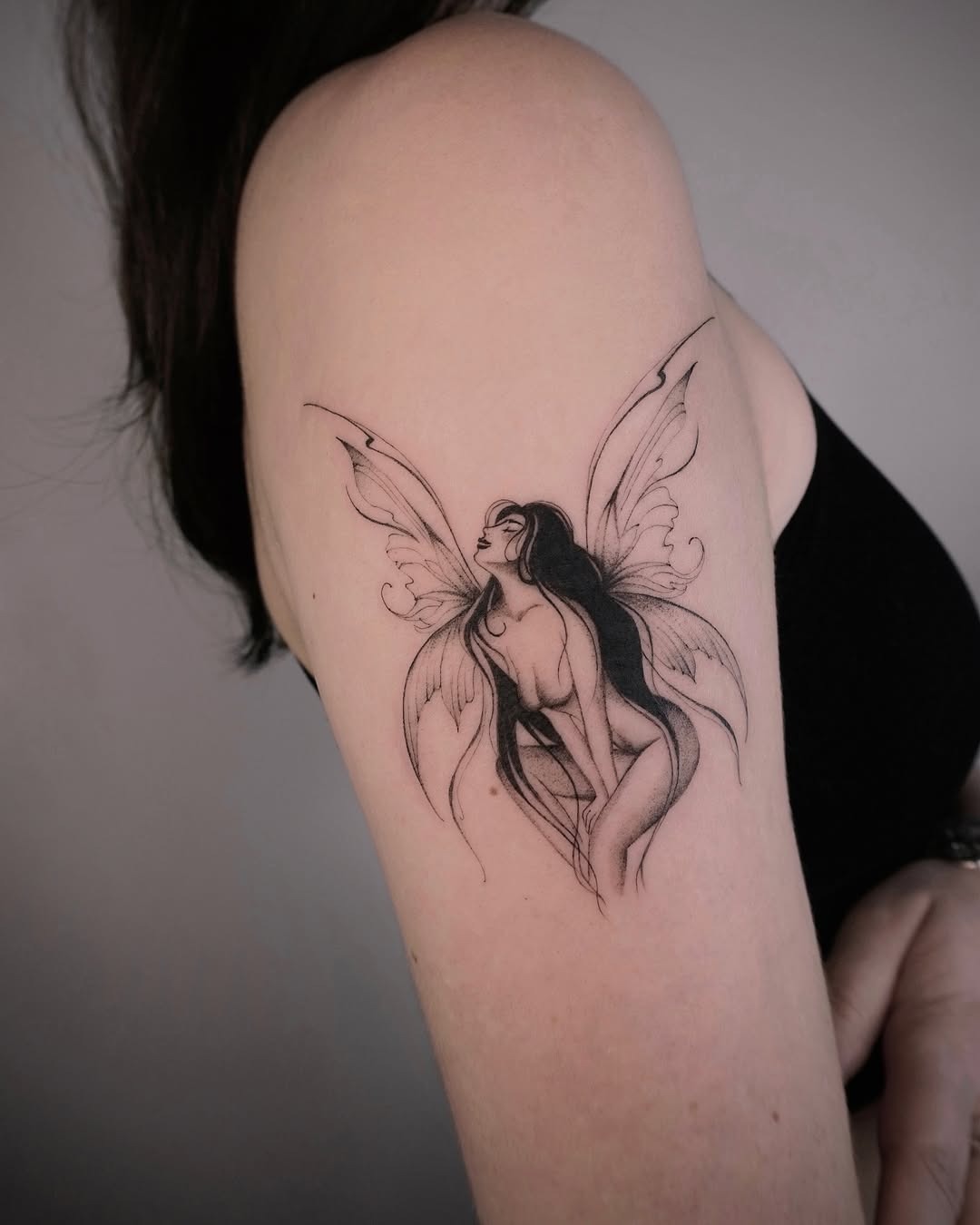 A graceful fairy tattoo with elegant wings Tattoo Design