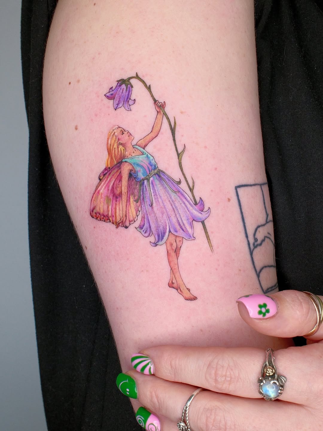 Enchanting fairy tattoo adorned with flowers Tattoo Design