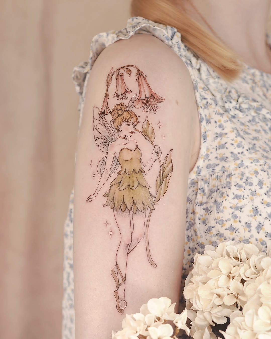 Enchanting fairy tattoo with floral elements Tattoo Design