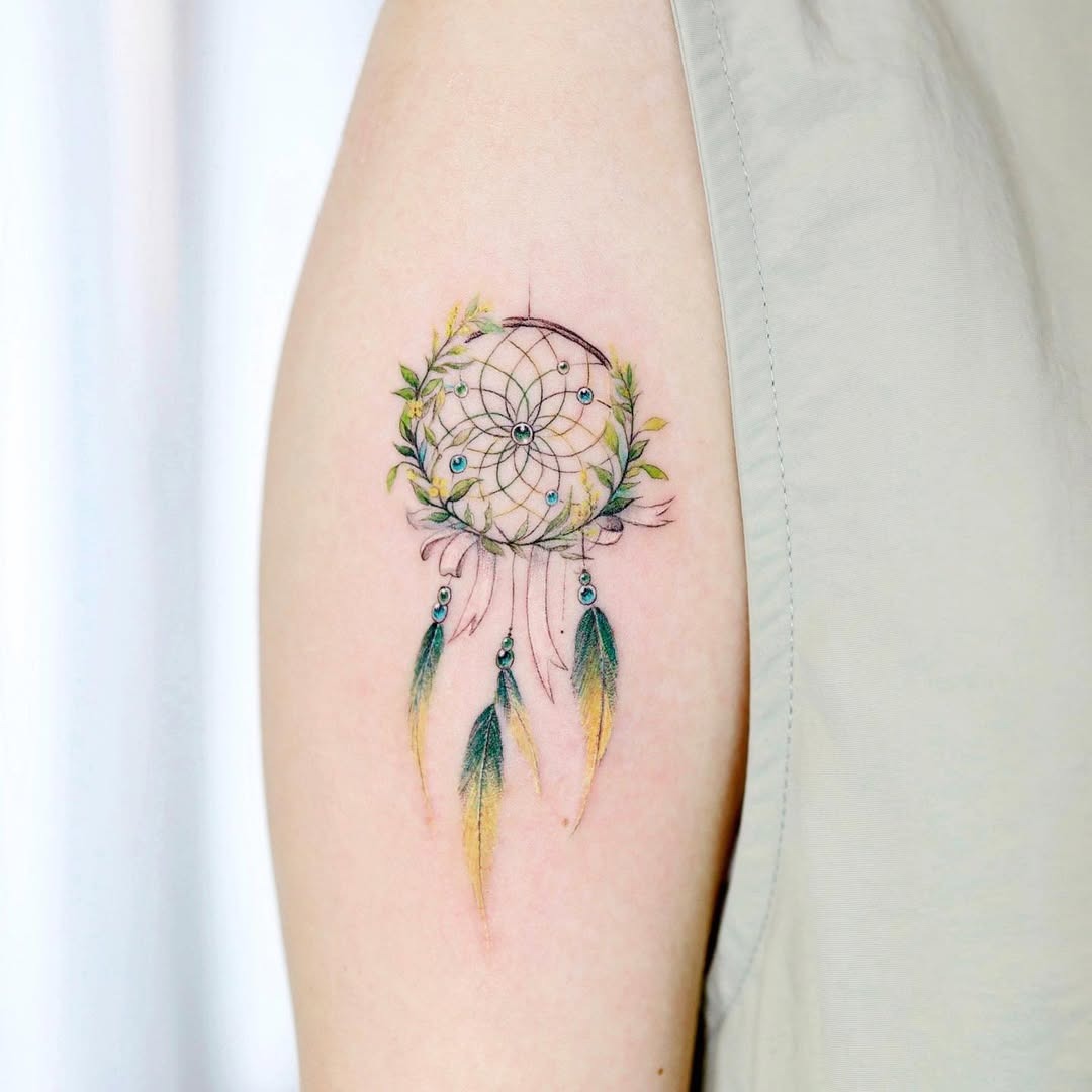 A vibrant dreamcatcher with delicate feathers. Tattoo Design