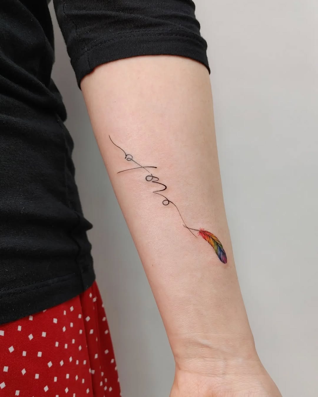 Colorful feather tattoo with inspirational script Tattoo Design
