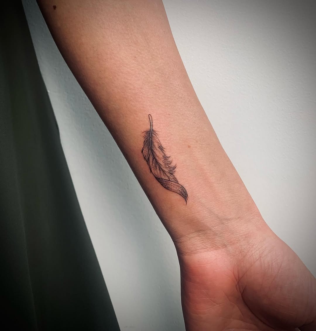 Delicate feather tattoo for minimalistic appeal Tattoo Design