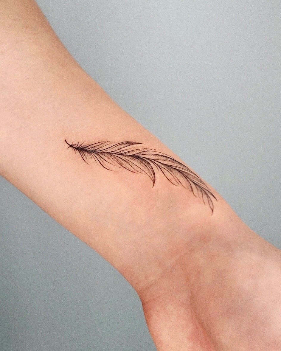 Elegant feather ink on the forearm Tattoo Design