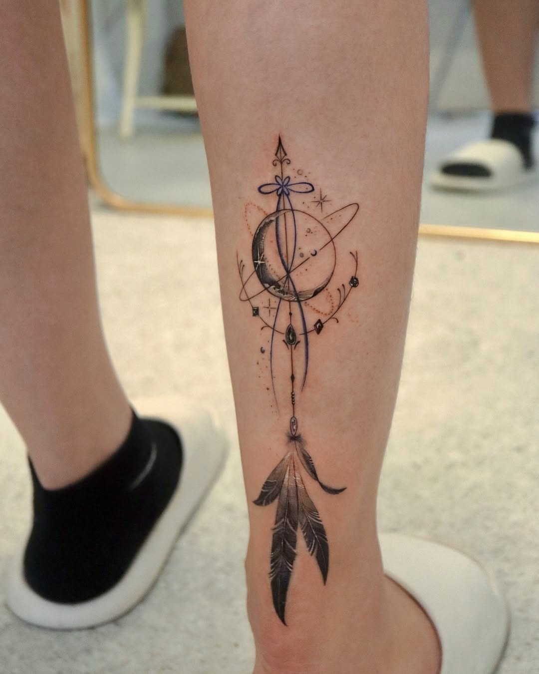 Elegant feather tattoo with geometric elements Tattoo Design