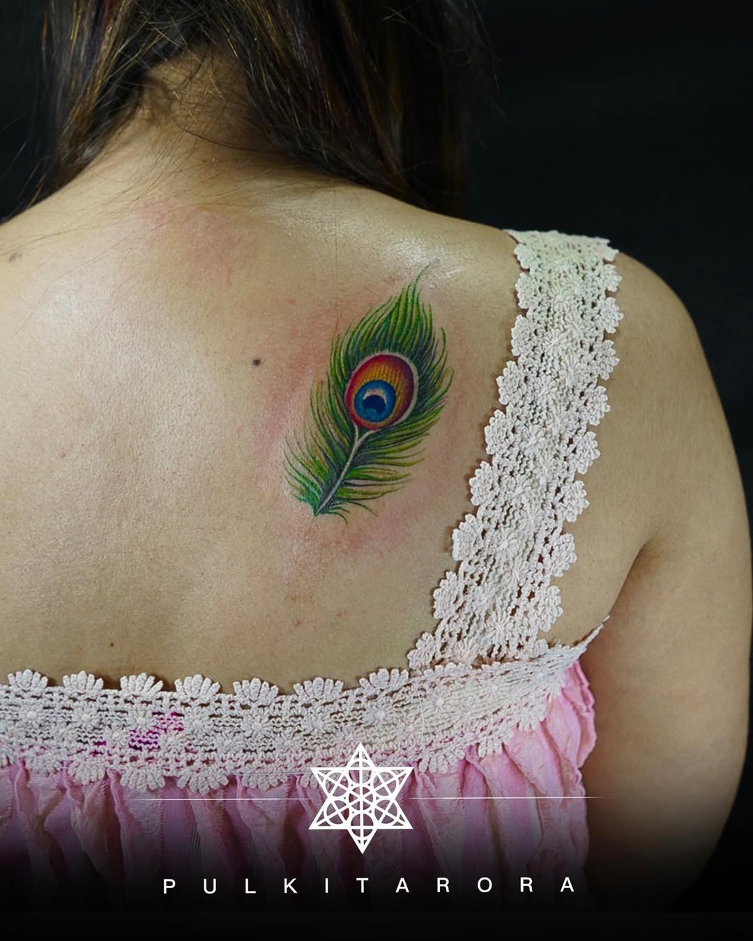 Stunning peacock feather tattoo on the back. Tattoo Design