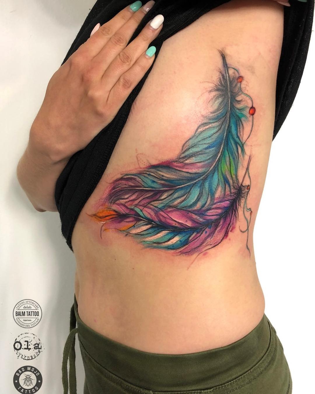 Vibrant feather tattoo showcasing colorful artistry Tattoo Design